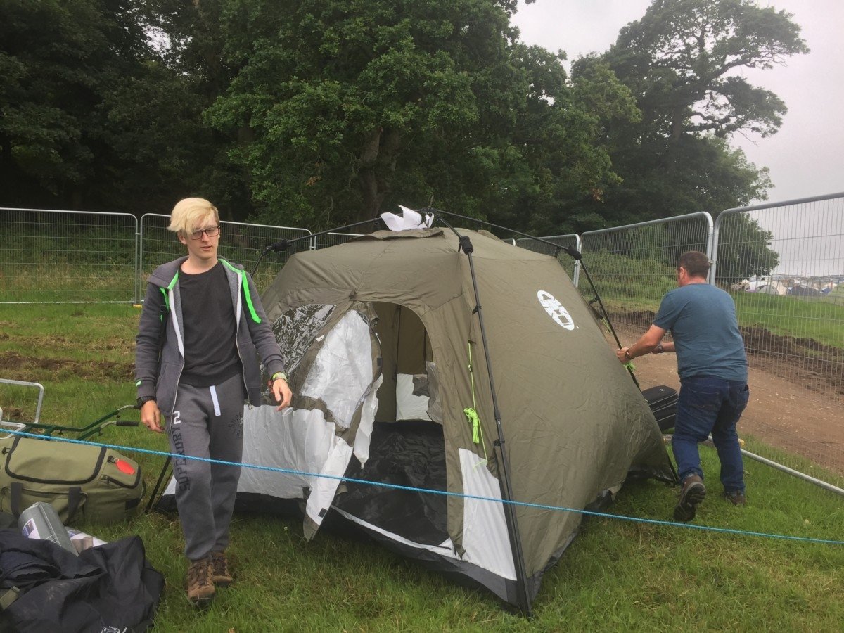pop up tent camping at a festival in the rain. The Luxury Guide to Surviving Festivals in the Rain