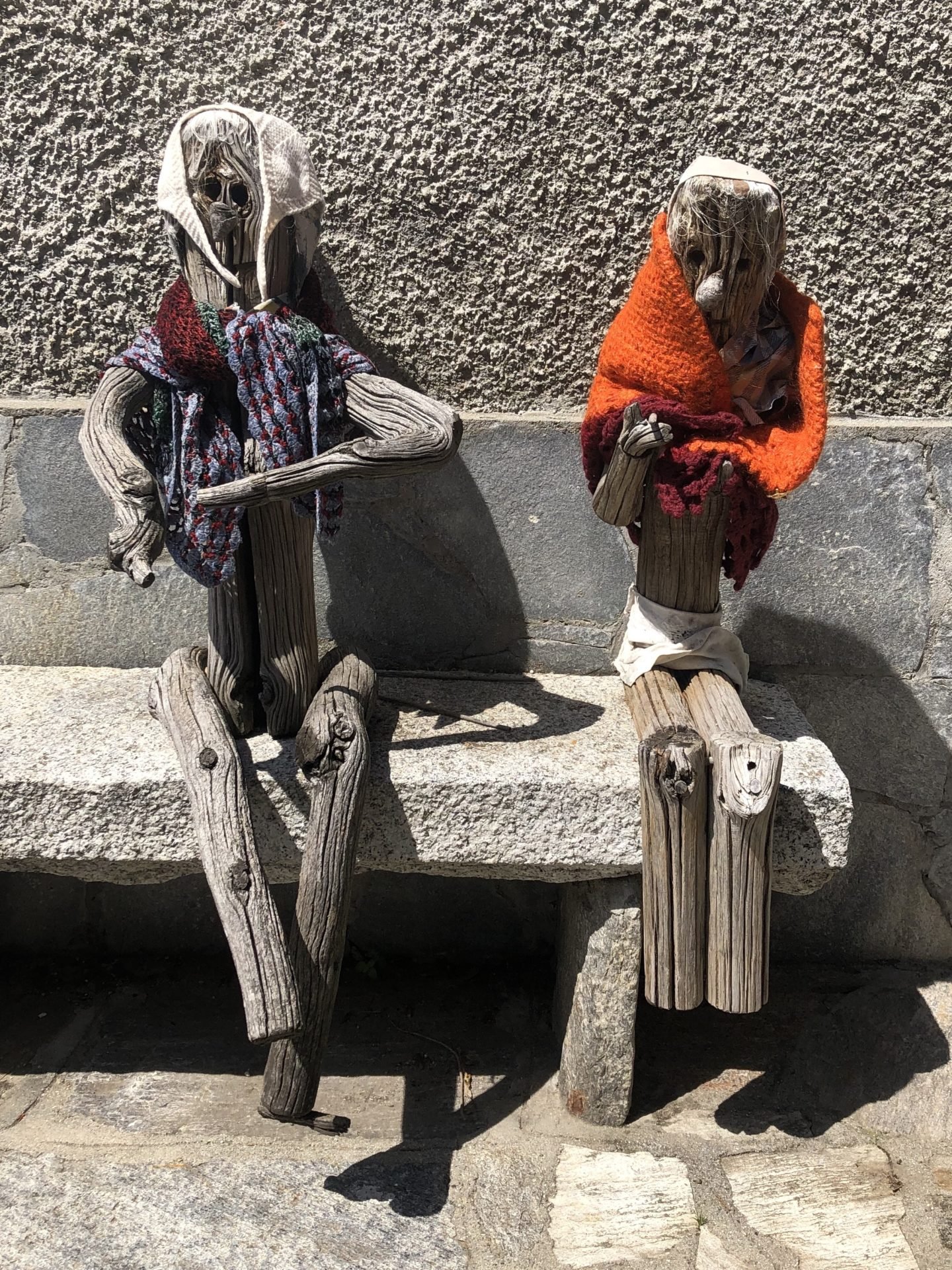 Two old ladies basking in the sun with their shawls in Musignano