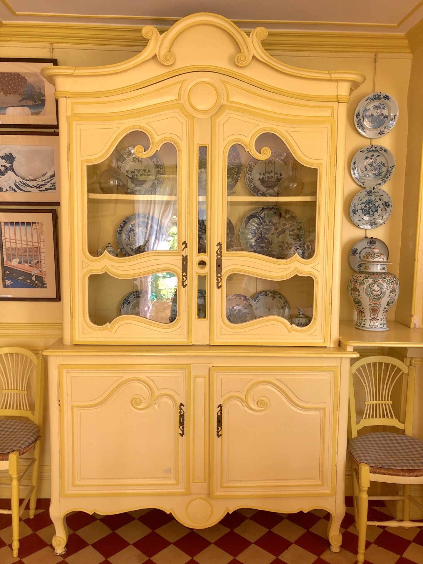Monet's yellow dining room, The yellow french dresser looks like the armoire from Disneys Beauty and the Beast.