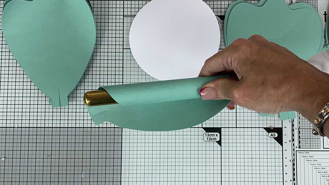 How to make large paper flowers with free template. Roll edges with a dowel or spoon handle
