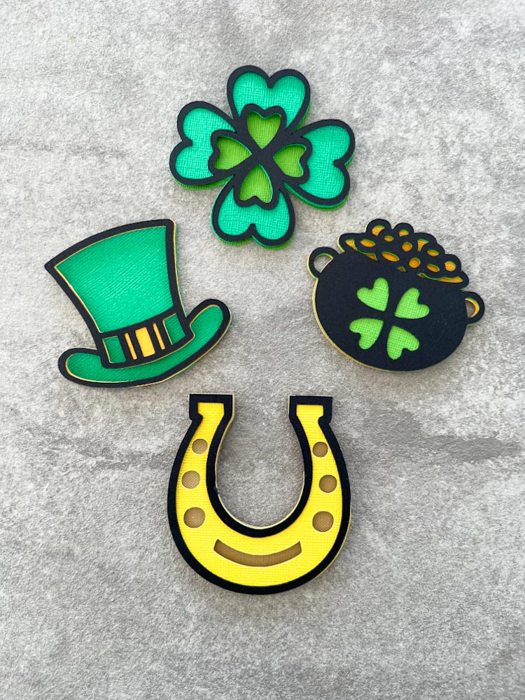 4 Free mini St. Patrick’s day SVGs, Shamrock, Leprechaun hat, Pot of gold and a horseshoe charm for all of your paper crafts and card crafts.